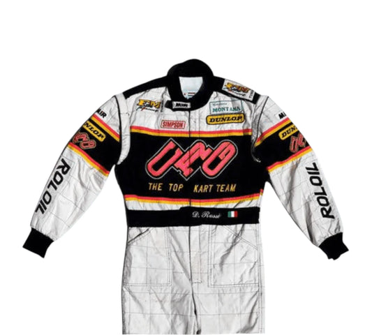 White racing suit with black and red accents featuring various sponsor logos on a white background