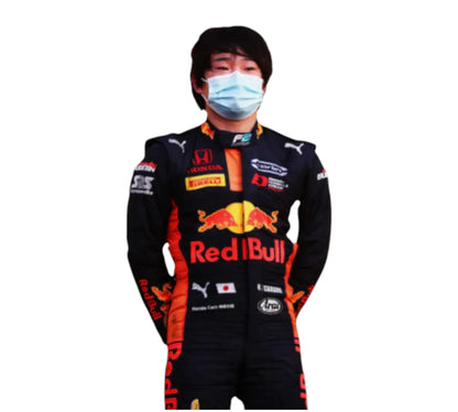 Person wearing a Red Bull racing suit with a face mask on a white background