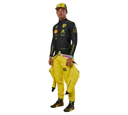Person wearing a black and yellow racing suit with visible branding on a white background