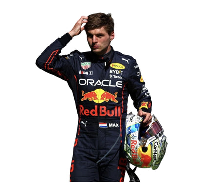 Person wearing a Red Bull racing suit holding a helmet on a white background
