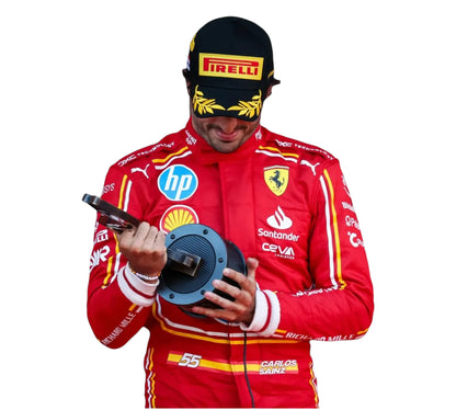 Person in a red racing suit holding a wheel, with visible branding on the suit and helmet.