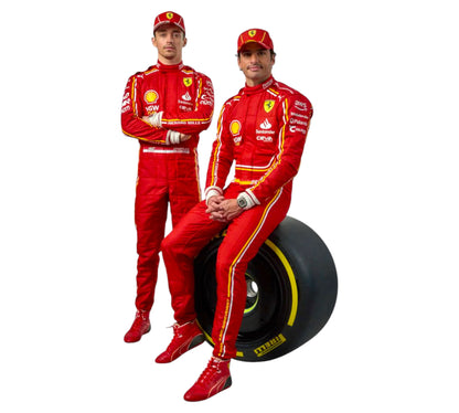 Two individuals in red racing suits with a large black tire between them on a white background