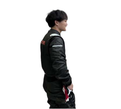 Person wearing a black racing suit with visible branding on a white background