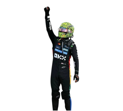 Person in a racing suit and helmet with raised fist on a white background